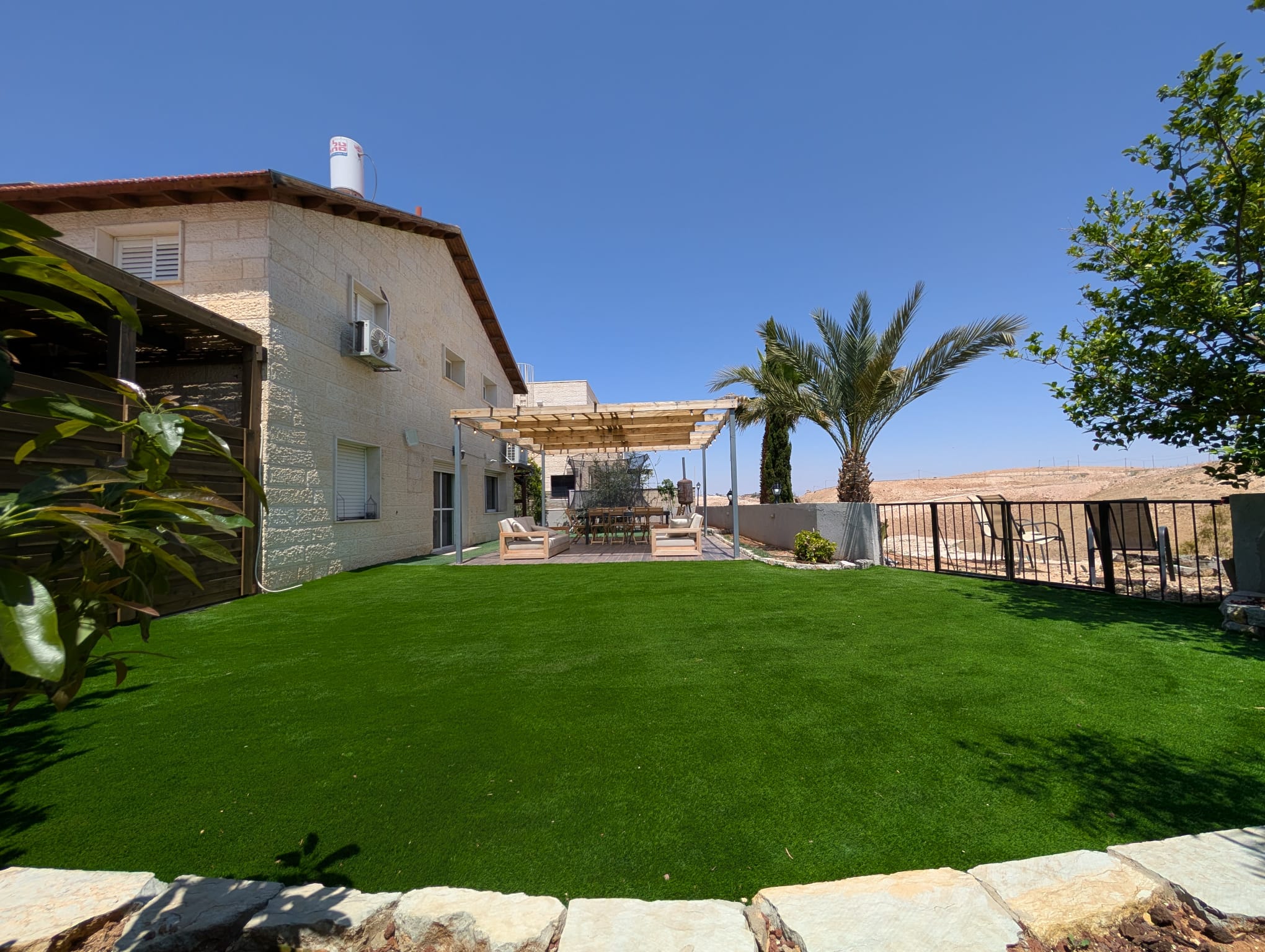 Large garden and villa exterior at Villa Neve Midbar