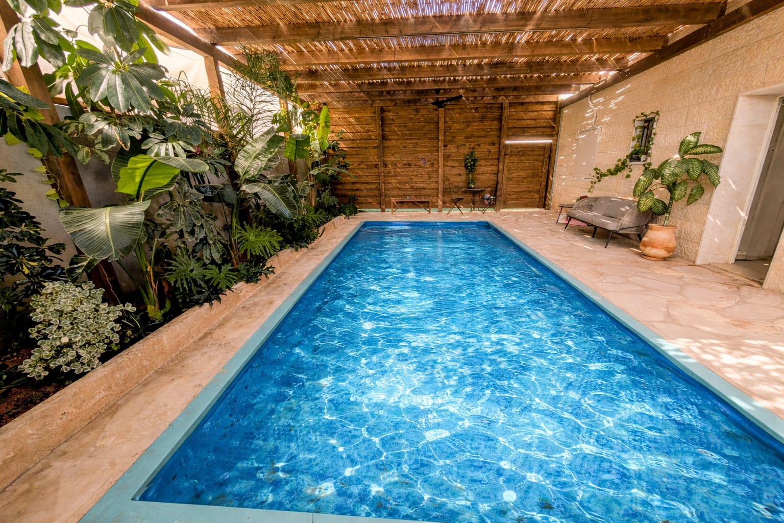 Pergola-covered private pool at Villa Neve Midbar